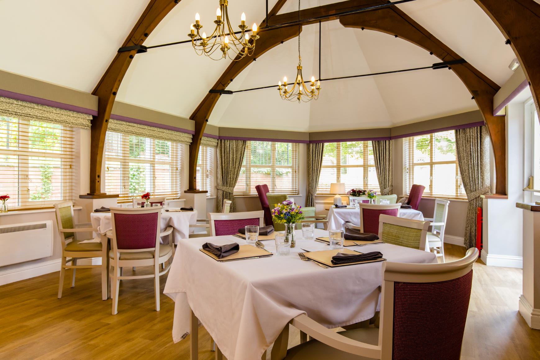 dining room with wooden beams and furniture